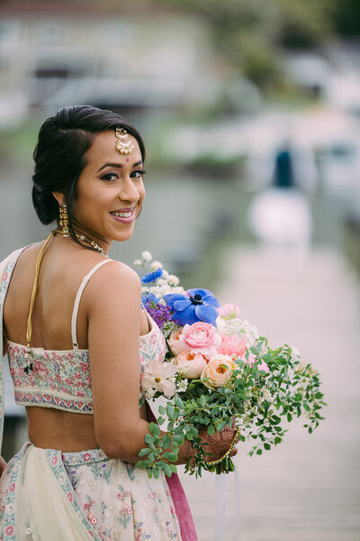Waterfront wedding reception with artistic floral design.