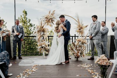 Bride and groom first kiss - CO Wedding Photo - Colby and Valerie Photography