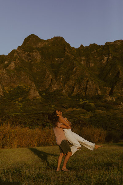 man holding woman and spinning her around