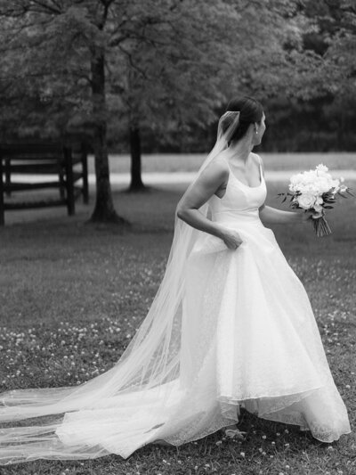 Bride carries dress at an outdoor venue in Atlanta