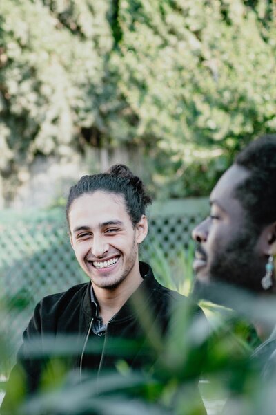 a black and a white men smiling and talking about mental health in nature