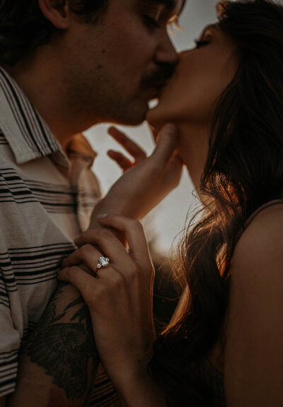 A couple kissing at golden hour capturing their engagement in Tennessee.