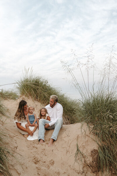 Family enjoying a fun photography session together on a Michigan beach
