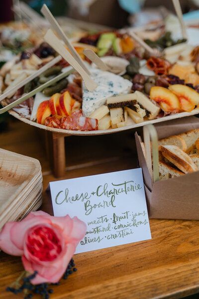 Charcuterie table sign with green watercolor lettering for Smith Farm Gardens event