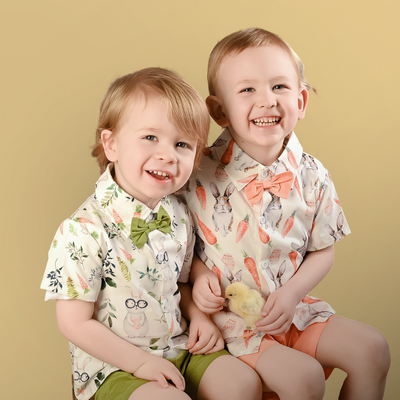 2 boys sit next to each other with a baby chick for their Iowa Mini Photographer