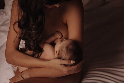 Mother breastfeeding her child during home lifestyle photography session