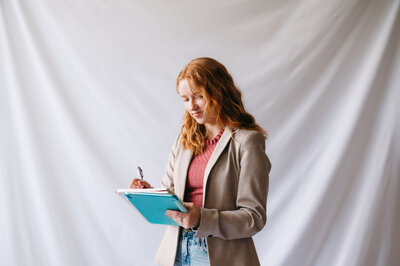 Emma, a brand designer holding an ipad