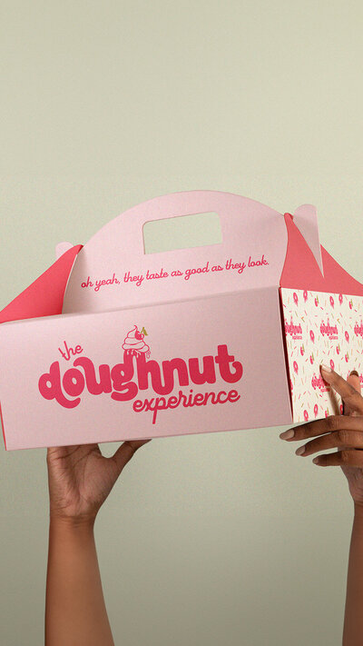 The Doughnut Experience boutique doughnut branding by Wildspark Creative. Female-led Michigan bakery gets custom logo, packaging, and brand identity with playful, feminine aesthetics designed to attract consumers and elevate retail presence.

Wildspark Creative designed The Doughnut Experience branding, packaging, and logo for a Michigan gourmet bakery. Feminine, boutique-focused design creates a cohesive, retail-ready, and consumer-friendly doughnut brand for female founders.