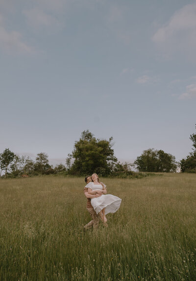 Cozy, intimate motherhood maternity photography with deep, rich tones and soft, golden-hour warmth, creating memories that last forever.