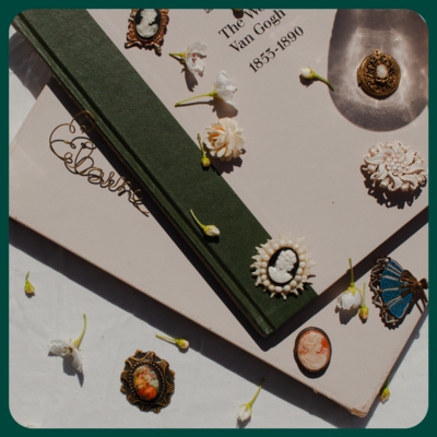Collection of vintage brooches scattered across art books