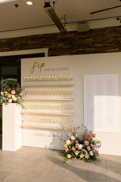 Rustic yet elegant wedding floral design by Leigh Florist with a mix of white and pastel flowers accented with greenery