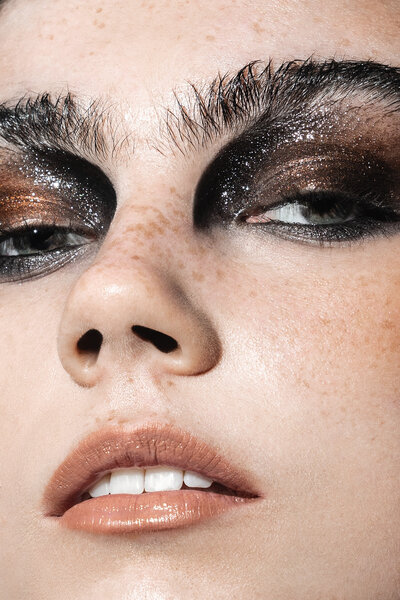 Beauty portrait of model with bold dark make-up