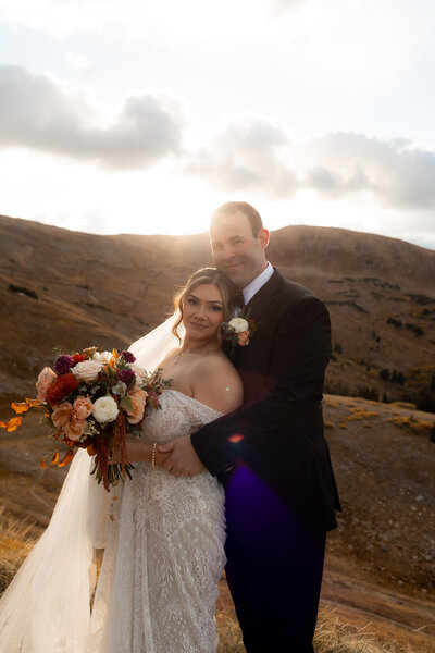bride and groom pose while breckenridge elopement photographer take photos