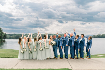 Wedding party laughing in front of a big sky at Lake Lanier Islands