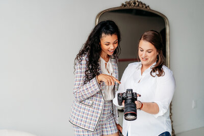 Photographer and client looking at the back of the camera.