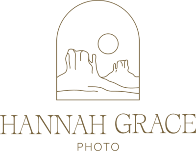 An olive green version of the Hannah Grace Photo logo. The Logo feautres a delicate handdrawn illustration of 2 buttes and the sun encased in an arch