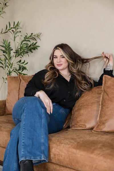Woman designer sitting at desk during brand photoshoot