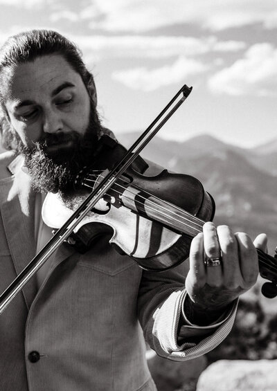 Live violinist performing at an intimate Colorado elopement ceremony in the mountains