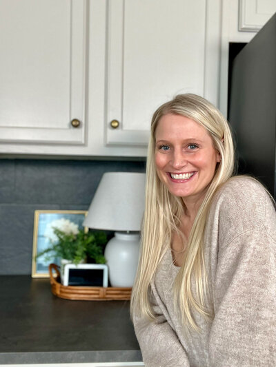 Haley standing next to her DIY kitchen
