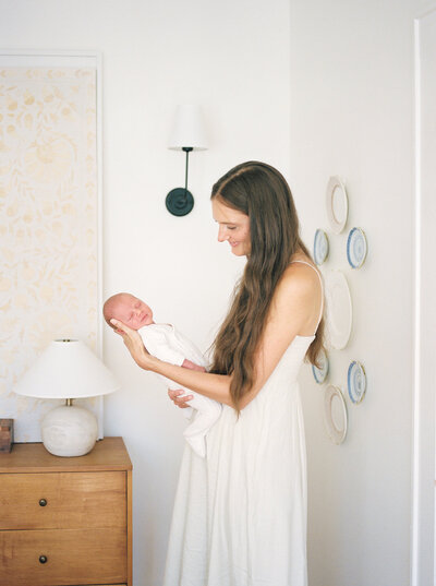 A mama holds her newborn baby during an at-home family lifestyle shoot by Chattanooga photographer Kelsey Dawn Photography