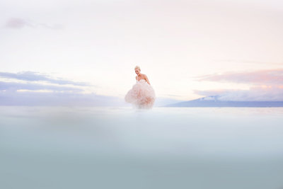 Maui photographers love and water trash the dress session with pink wedding gown at sunrise