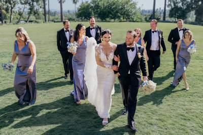bridal party walking in the garden of the langham hotel in pasadena