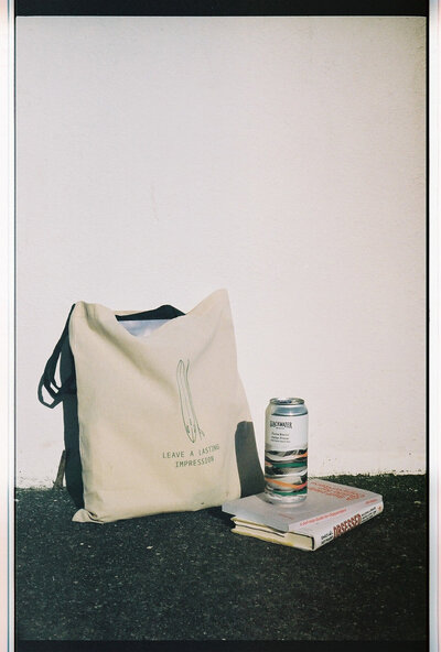 bag of copywriting books with a beer
