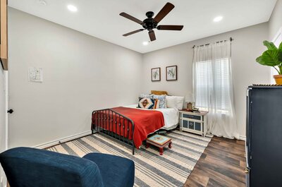 Master bedroom with private bathroom and Queen bed in this three-bedroom, two-bathroom vacation rental house just 5 minutes from The Silos in downtown Waco, TX.