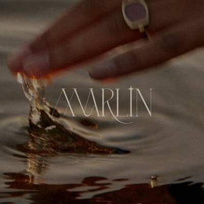 Hand in water with logo on top