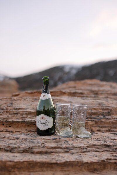 champagne in glass boots for engagement photos