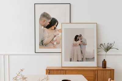 Two framed prints on side table.