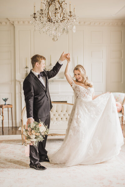 Wedding Photographer & Elopement Photographer Husband twirls wife in historic venue