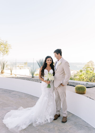 bride and groom portrait with the ocean in the background