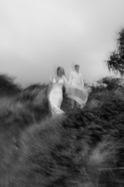 couple walking through grass