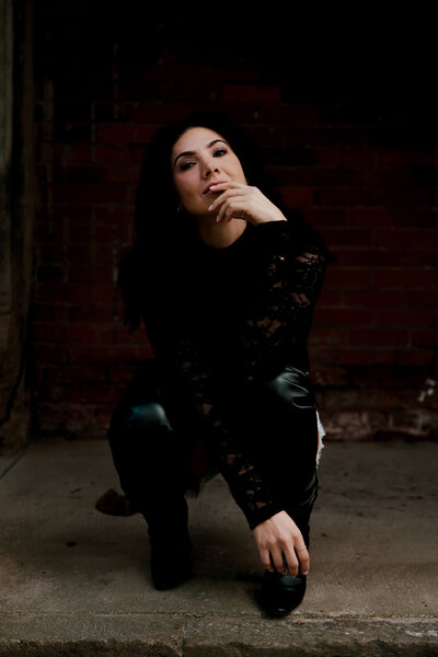 Portrait of Angelica Ray in a thoughtful pose, representing intuitive guidance and personal transformation.