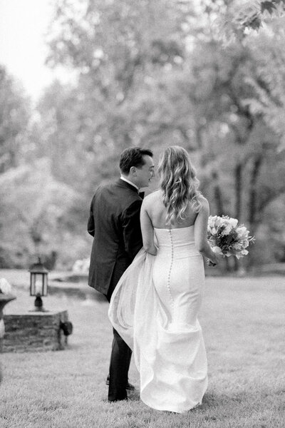 Bride and Groom walking on the front lawn at The Clifton in Charlottesville, Virginia.