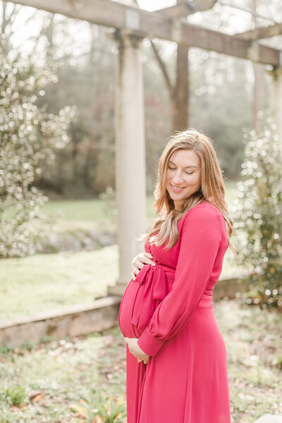Expecting mother cradling her belly -Family Photographer Greenville SC