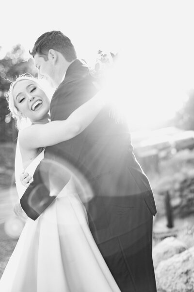 bride embraces her groom with the most cheerful smile right after they tie the knot elegant colorado wedding photographer kari joy photography