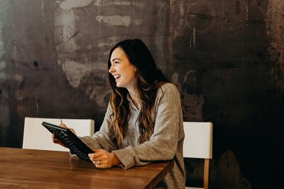 Discover how our Canadian virtual assistants can support your business. Image shows a professional working at a table, highlighting the efficiency and dedication of our virtual assistant team. Photo by Brooke Cagle on Unsplash.