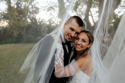bride and groom pose for pictures on wedding day in dallas