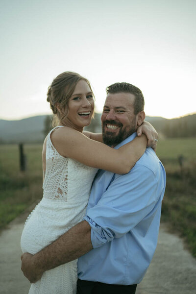 bride and groom hugging and smiling