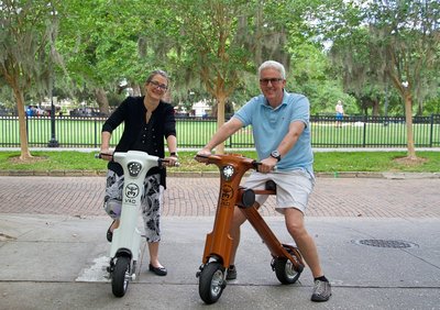 Couple riding white and bronze Go-Bike M1 around Orlando Florida Lake Eola