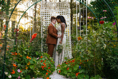 Two Brides embracing under their Wedding arch at their Destination Elopement in the Berkshires
