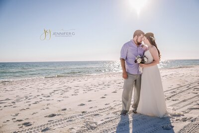 Bride and groom looking into each other eyes on the beatiful white sand at Henderson Beach State Park in Destin, FL