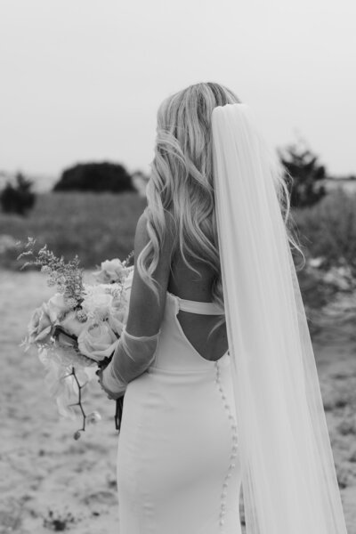 bride holding flower bouquet at the beach
