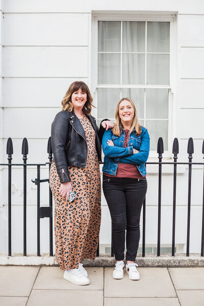 the two lauras standing in front of some metal railings