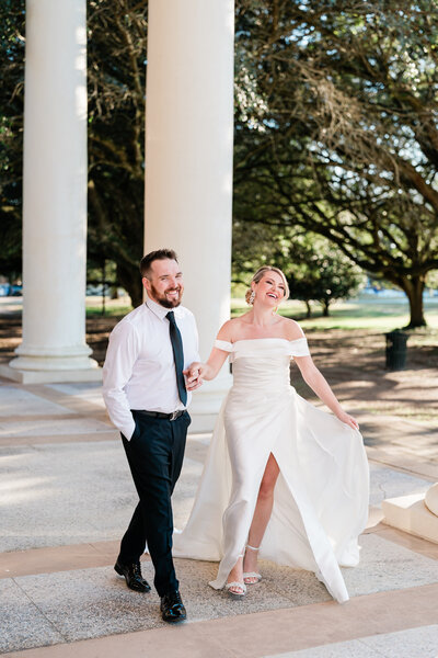 Bride and groom laughing and posing outside in Alabama