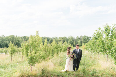 earth to table farm wedding-couple-in-orchard-1