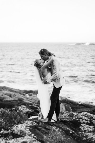 A special moment unfolds as our newlywed couple shares a kiss by the bay.