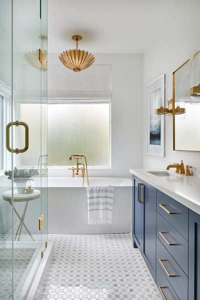 beautiful bathroom with tub and blue vanity in Toronto home